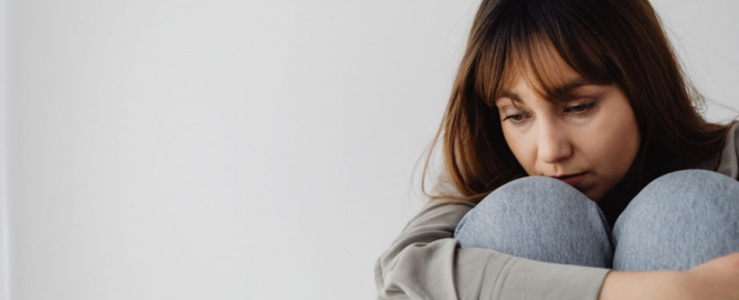 An image of a woman looking sad
